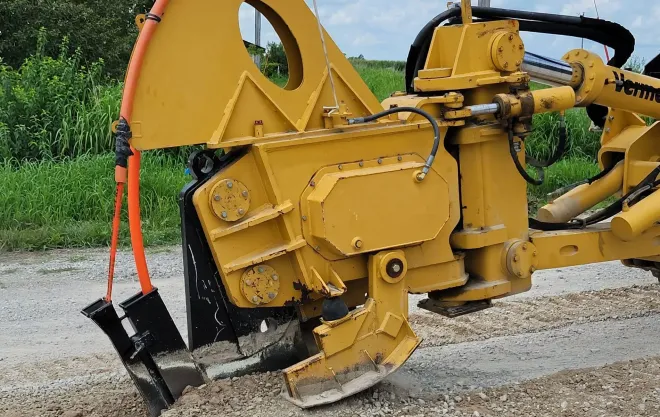 A yellow tractor with a shovel attached to it