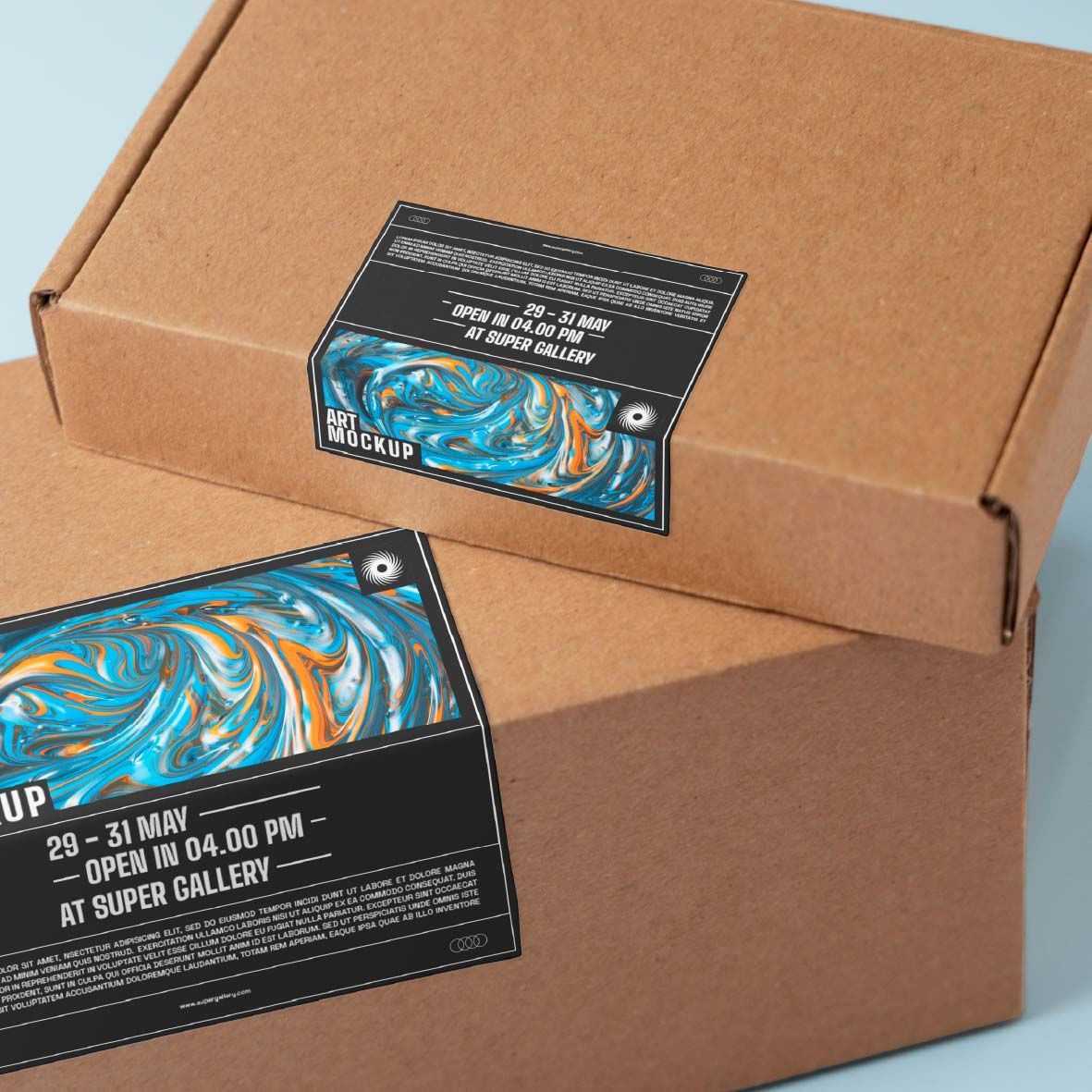 Two brown cardboard boxes stacked, each featuring a black label with blue and orange marbled art and text about an event.