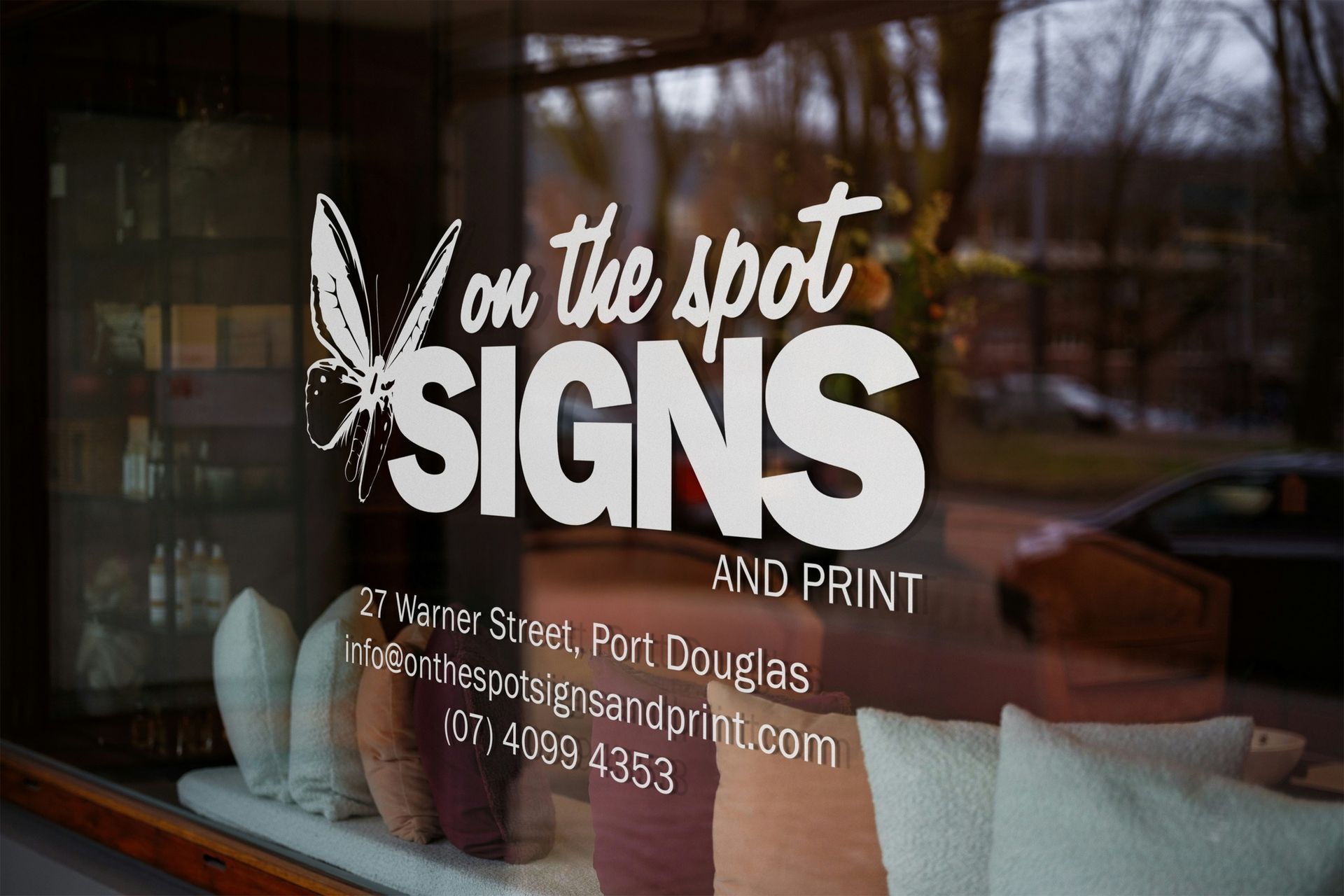 White vinyl business sign on a window for