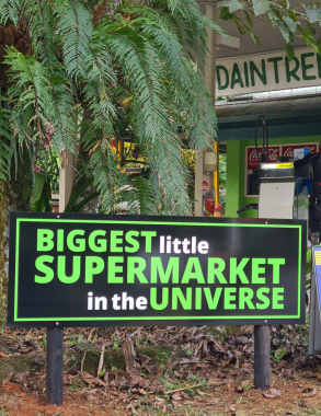 A black sign with lime-green text reading