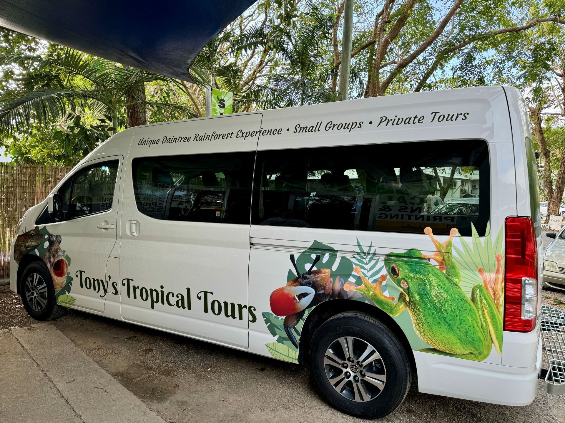 A Van Decorated with Large Colorful Images of A Frog and A Bird — On The Spot Signs Port Douglas In Port Douglas, QLD