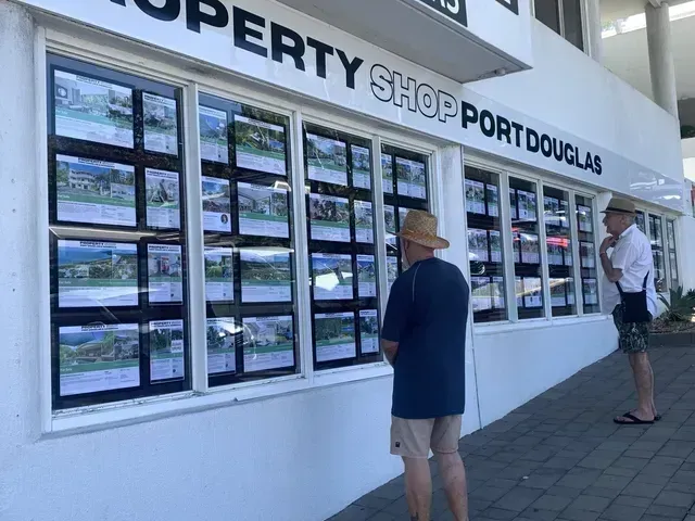 Two People Looking at Property Listings — On The Spot Signs Port Douglas In Port Douglas, QLD