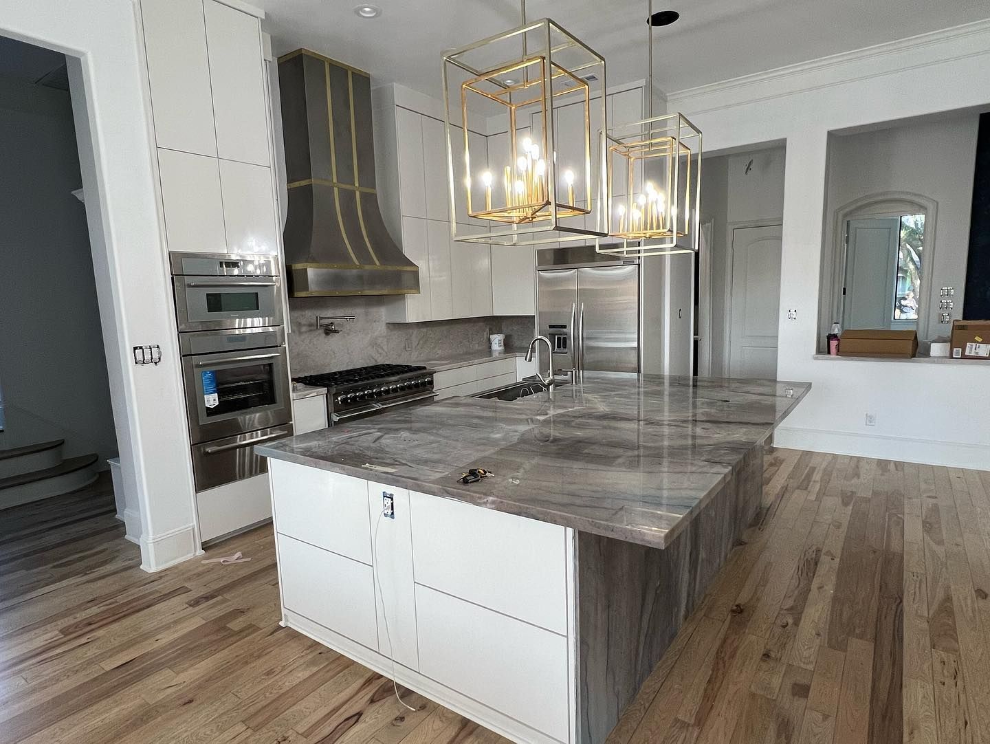 A kitchen with a large island and stainless steel appliances.