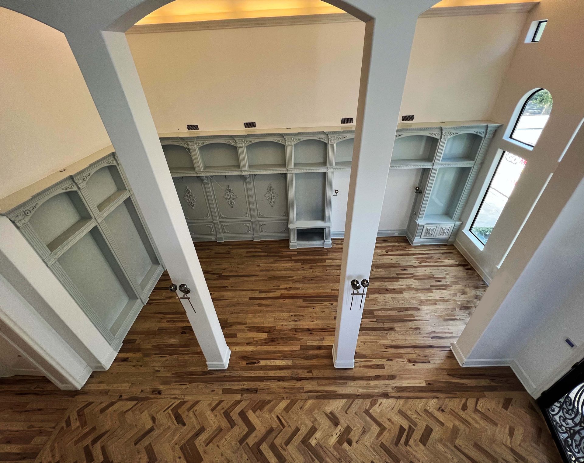 An aerial view of a living room with hardwood floors