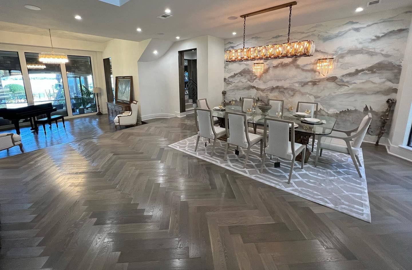 A large dining room with a dining table and chairs and a rug.