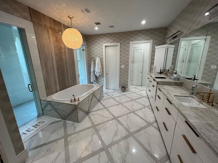 A bathroom with a bathtub , sinks , and mirrors.