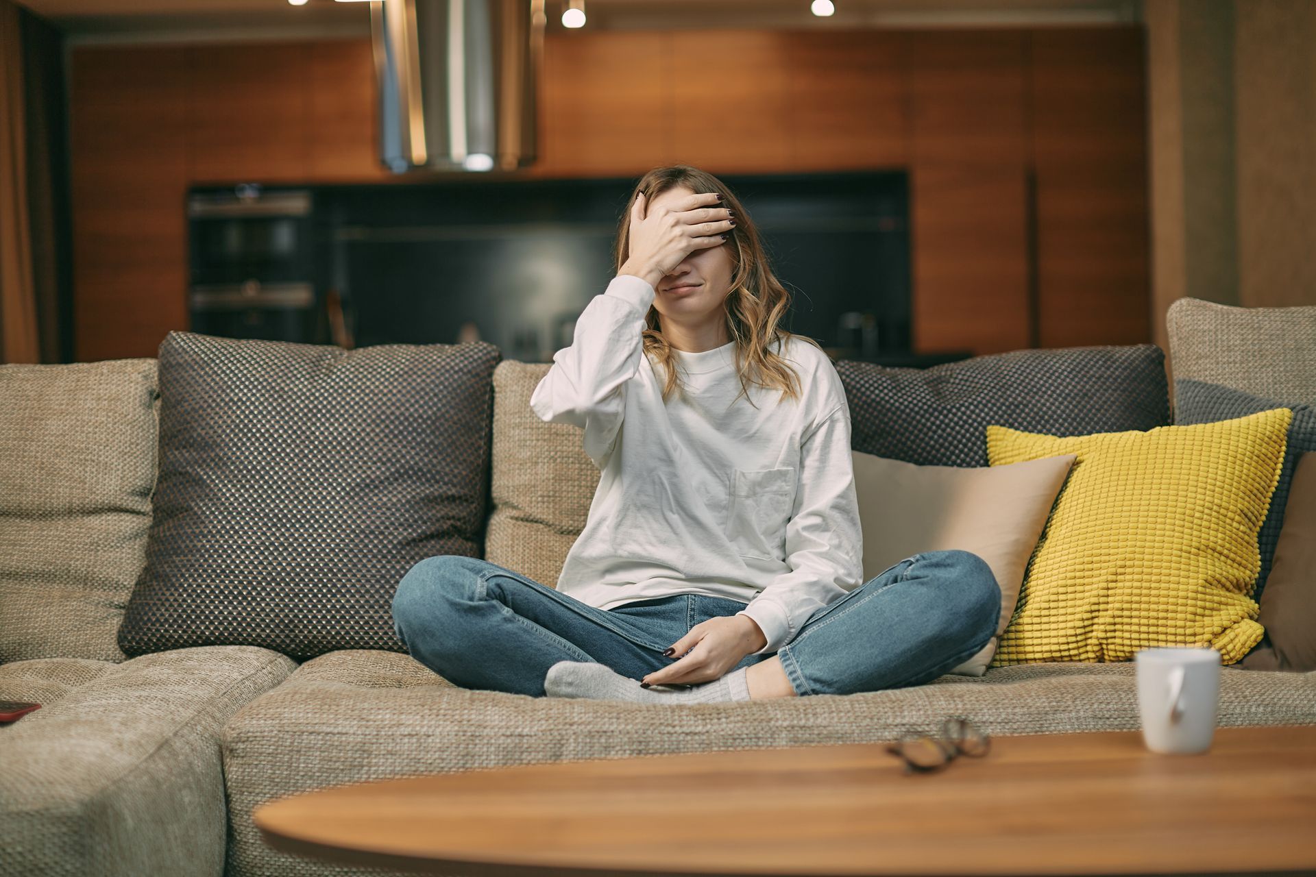 A woman in patterned pyjamas sitting on a bed depicting menopause fatigue at home A woman in patterned pyjamas sitting on a bed depicting menopause fatigue at home