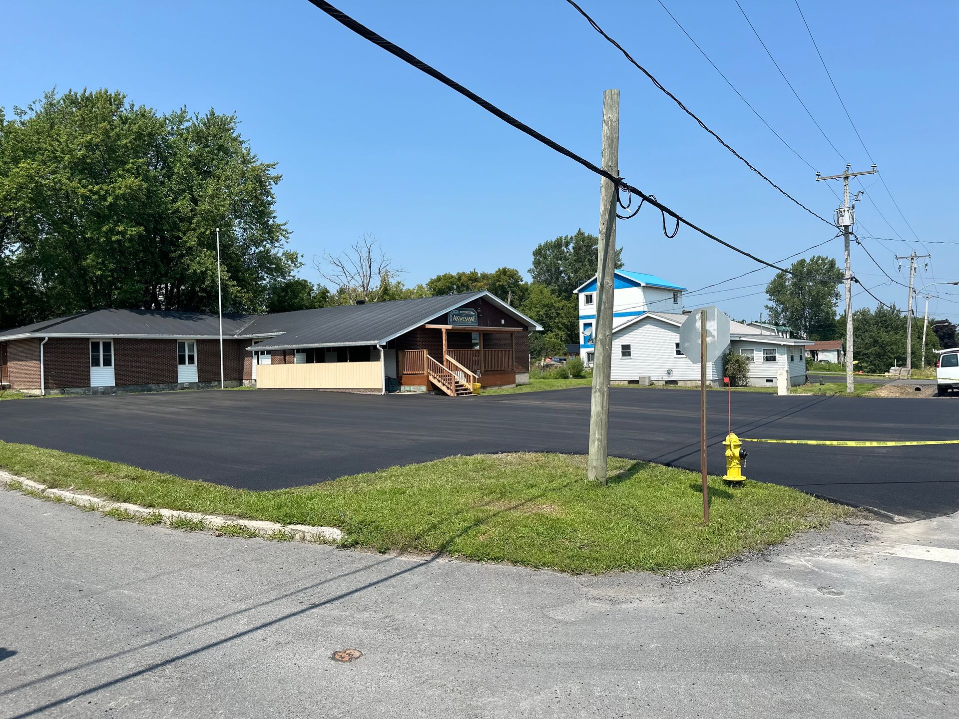 A large parking lot with a house in the background
