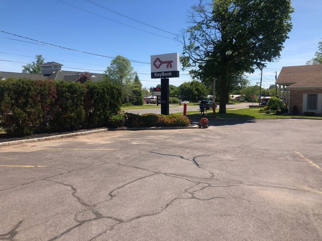 A parking lot with a sign that has a key on it