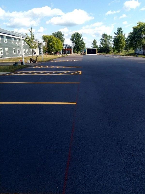 A parking lot with a building in the background