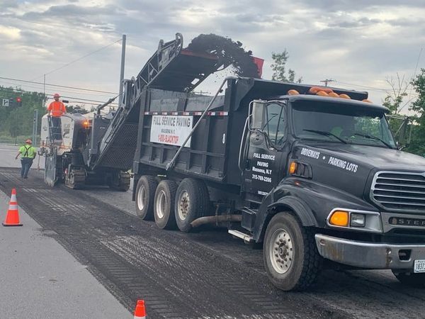 A dump truck is parked on the side of the road.