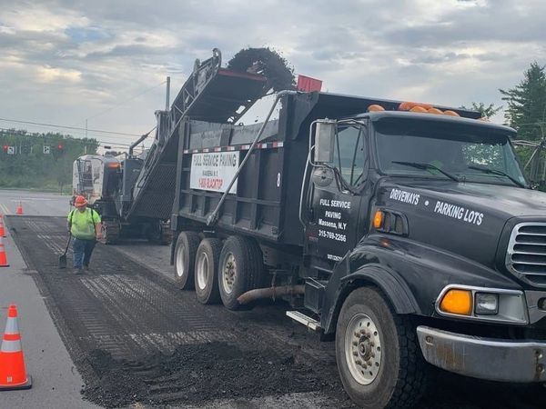 A dump truck is parked on the side of the road.