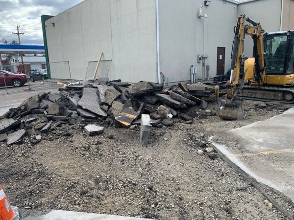 A large pile of dirt is sitting in front of a building.