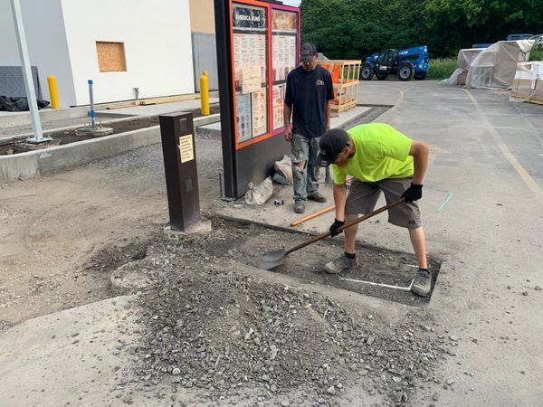 A man is using a shovel to dig a hole in the ground