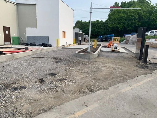 A construction site with a white building in the background