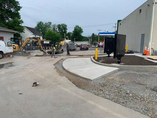 A construction site with a concrete walkway being built