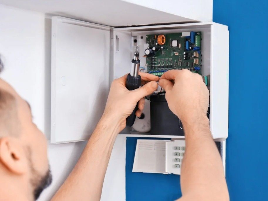 Derbyshire Electrical Specialists testing a burglar alarm in Derby