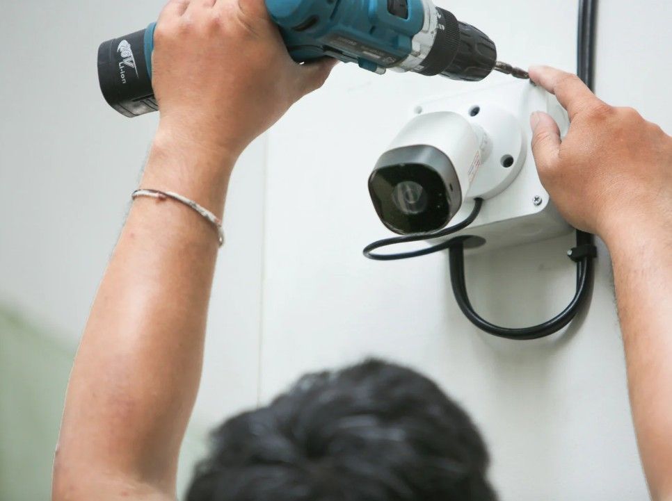 Installing a wired in outdoor security camera for a business in Derby