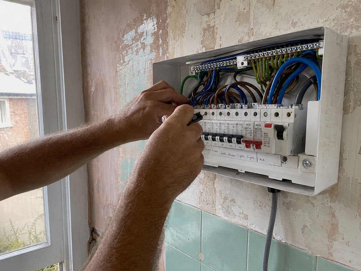 NAPIT-registered electrician carrying out consumer unit work at an Ilkeston property