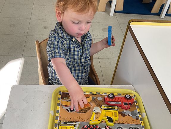 montessori child working with practical life activity