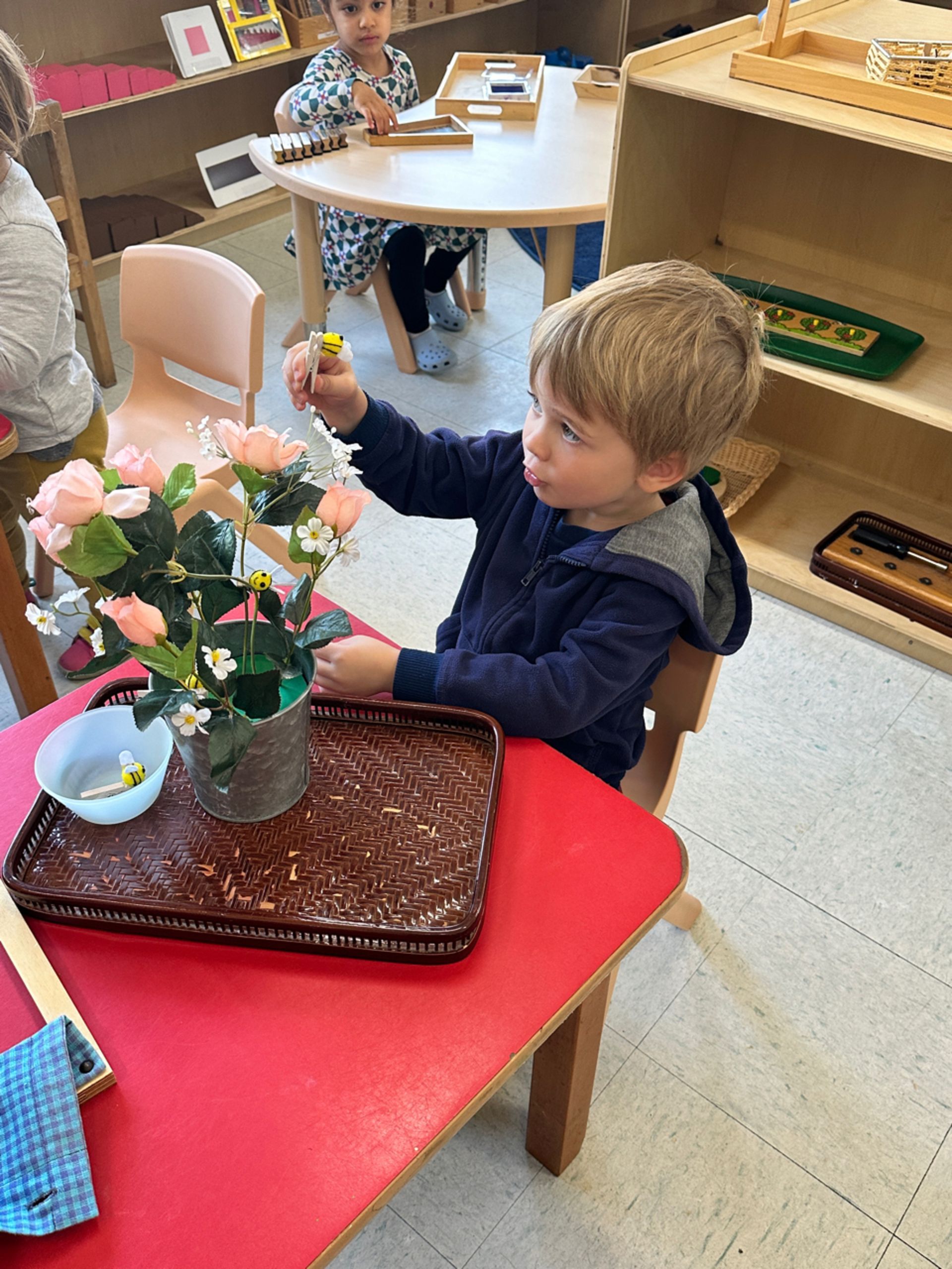 montessori child working with flower arrangement activity