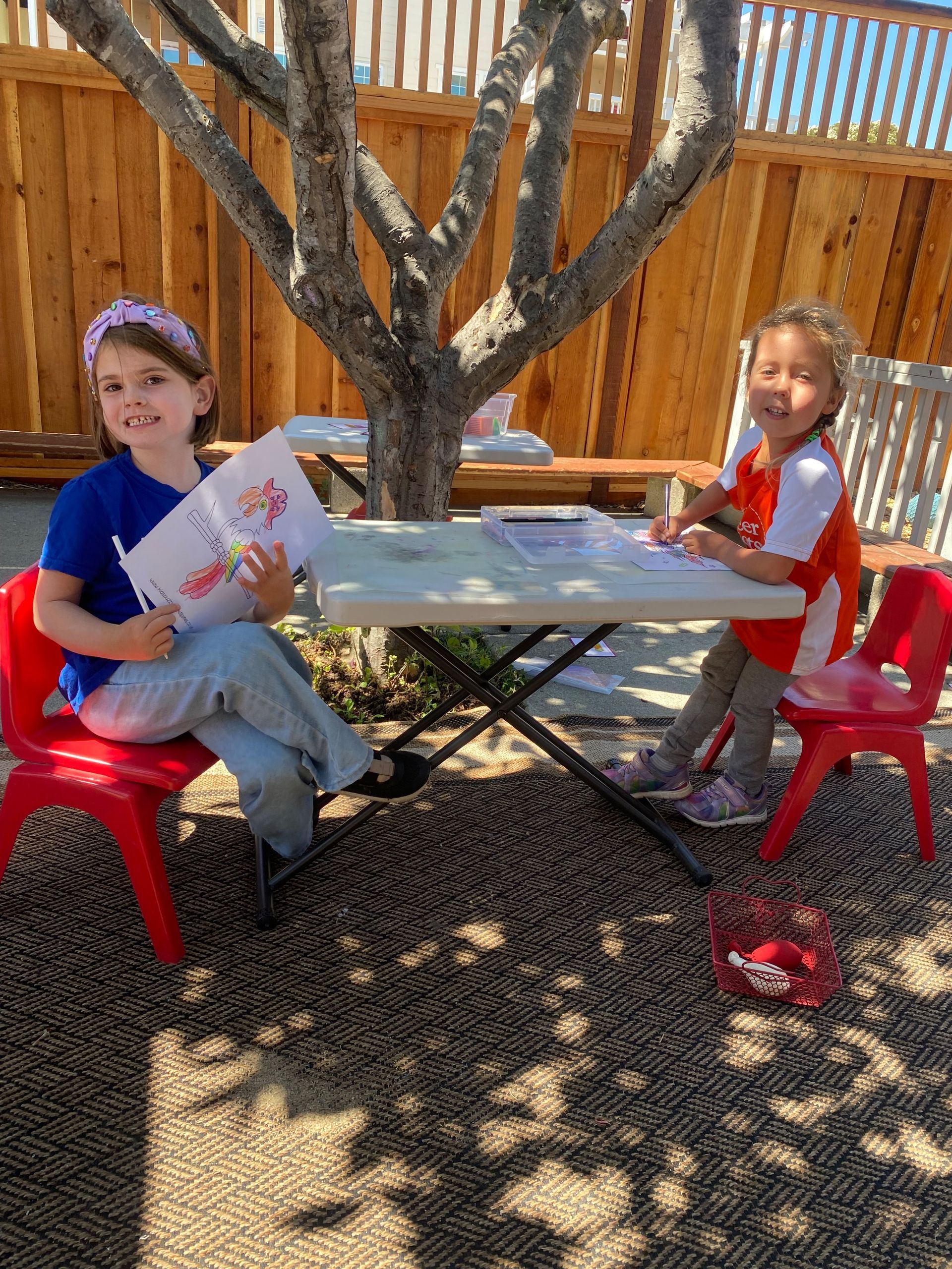 montessori children working with painting activity outside the classroom