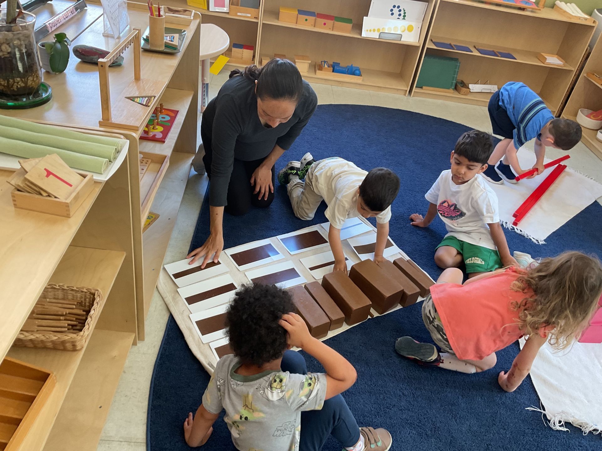 Montessori guide and children in the classroom