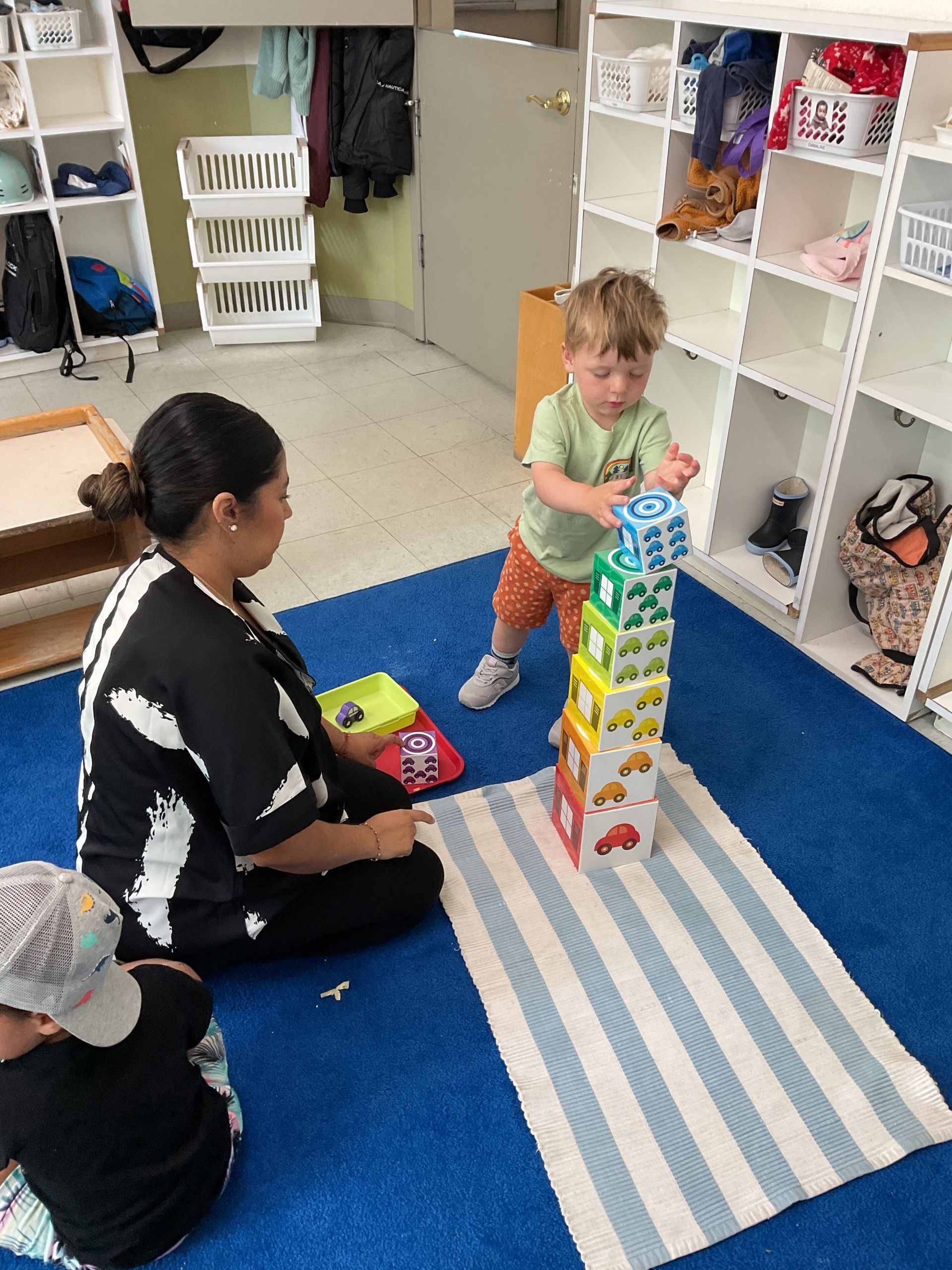 Montessori child and guide working in the classroom 