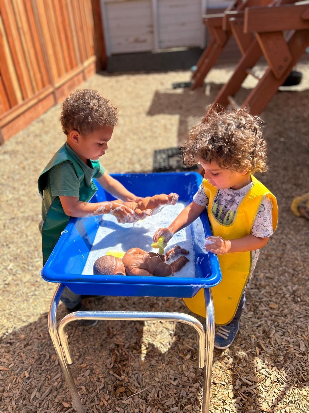 montessori children working outdoors on a practical life activity