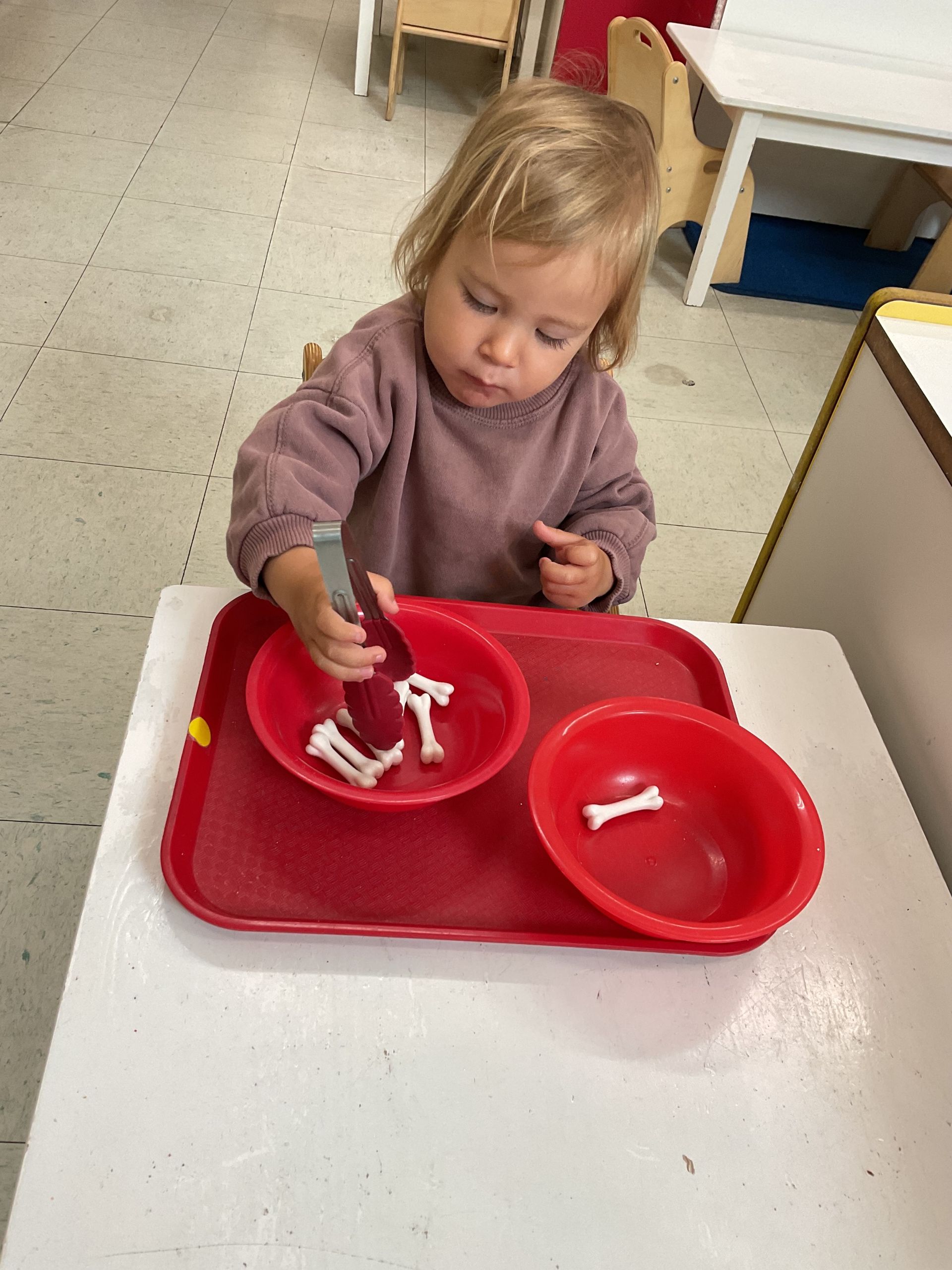 montessori toddler working with practical life activity