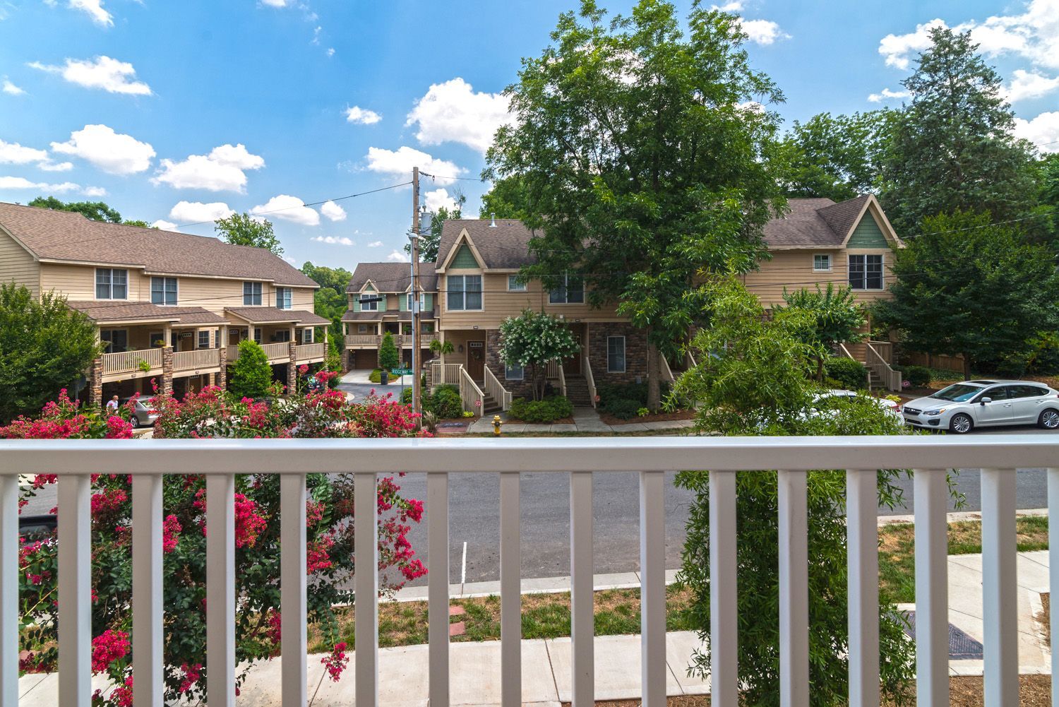 View of the community from a balcony showing well-kept buildings and landscaping.