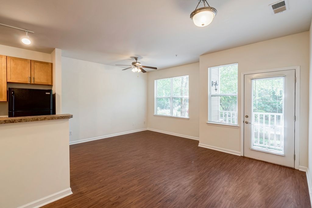 Spacious apartment living area with kitchen and large windows
