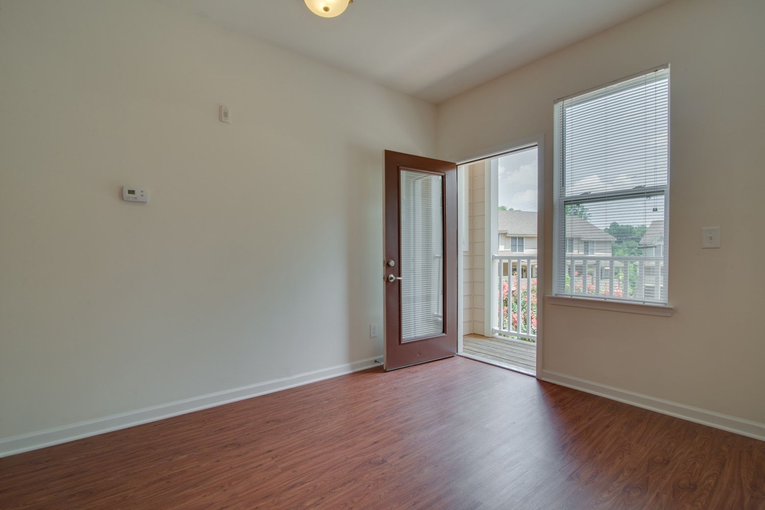 Interior view of an apartment with a door leading to a porch.