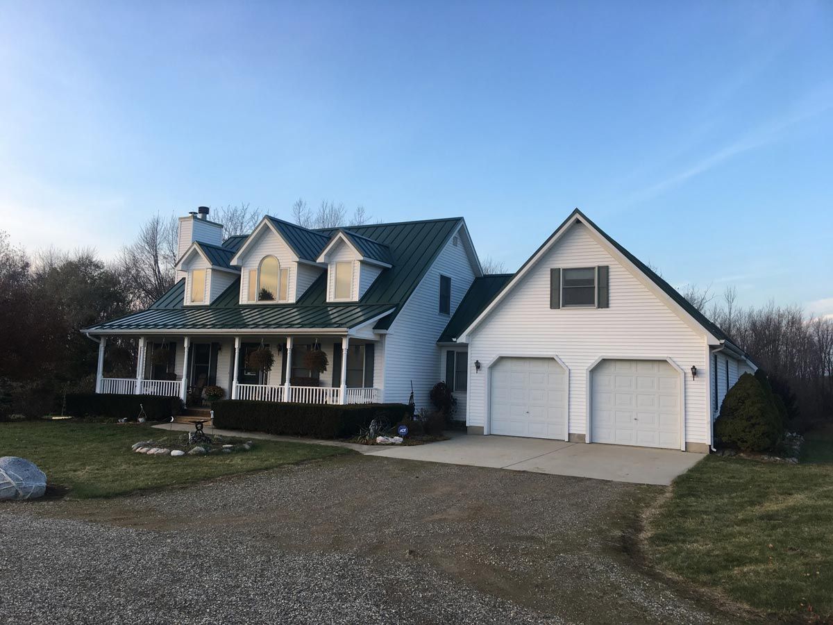 Standing seam metal roof on a home, showcasing expert craftsmanship and a modern, clean design. Serving Gaylord, MI with premium roofing.