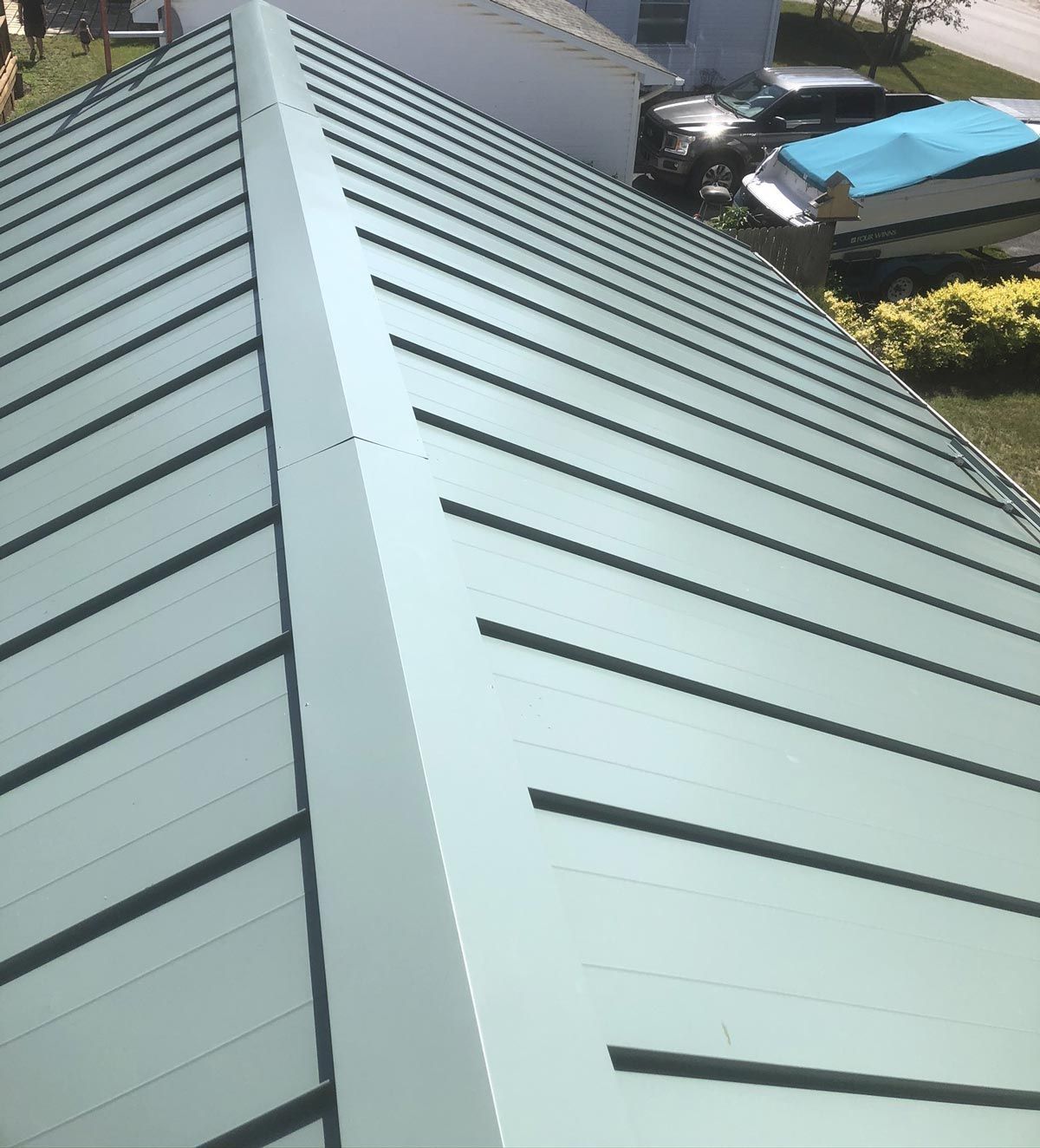 Metal roofing installation on a home, emphasizing high-quality craftsmanship and long-lasting protection. Serving Gaylord, MI.