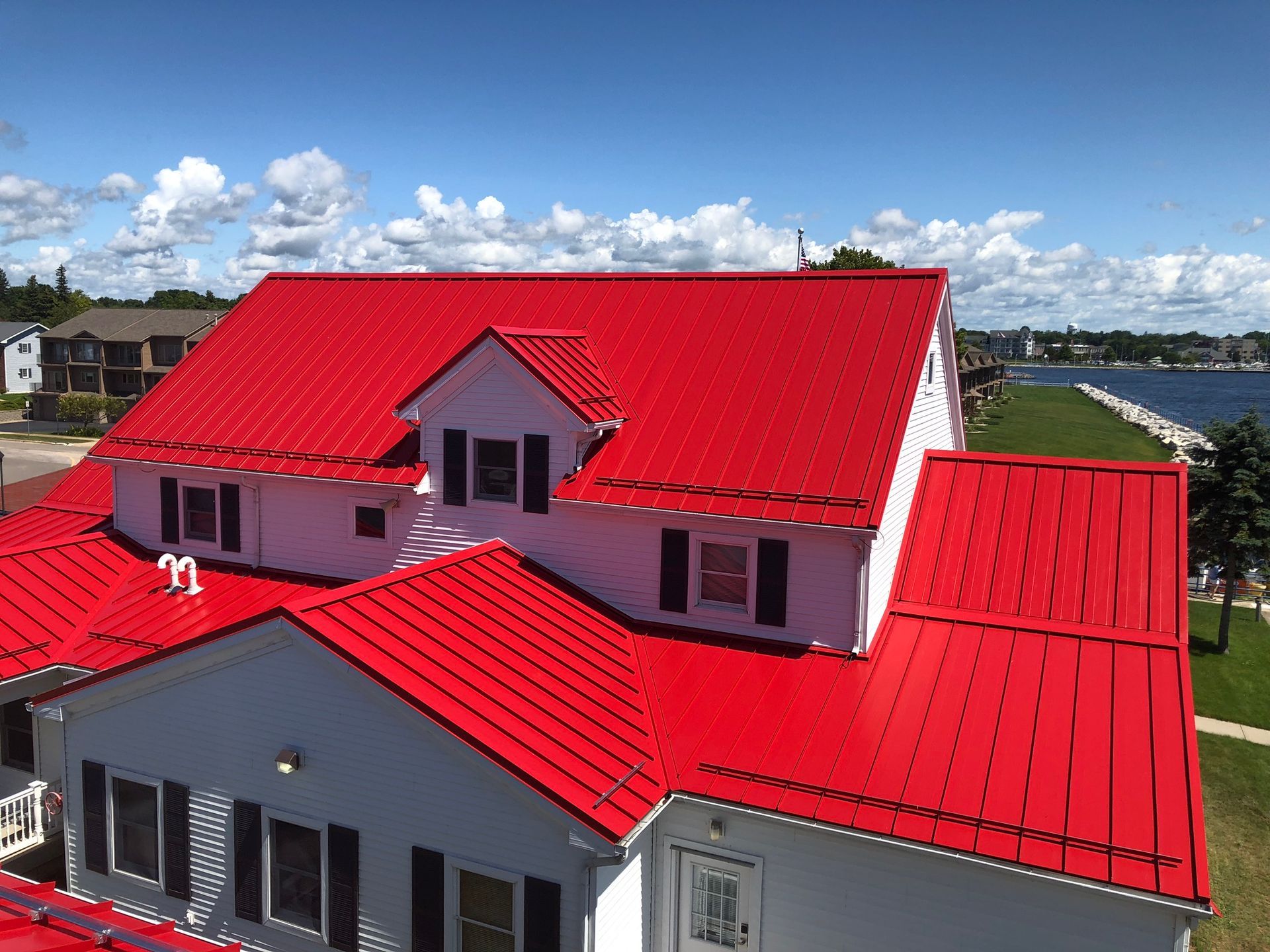 Aerial view of a coast guard building with a high-quality metal roof, demonstrating smooth lines and expert installation. Serving Gaylord, MI.