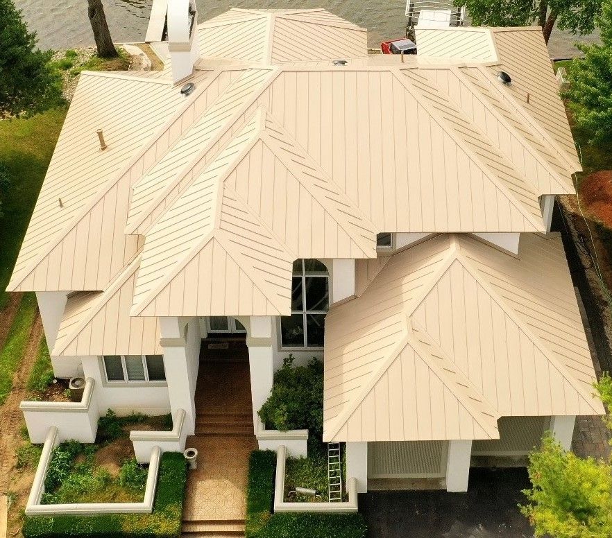 Home showcasing a modern metal roof, combining aesthetic appeal with high-performance protection. Roofing contractor serving Gaylord, MI.