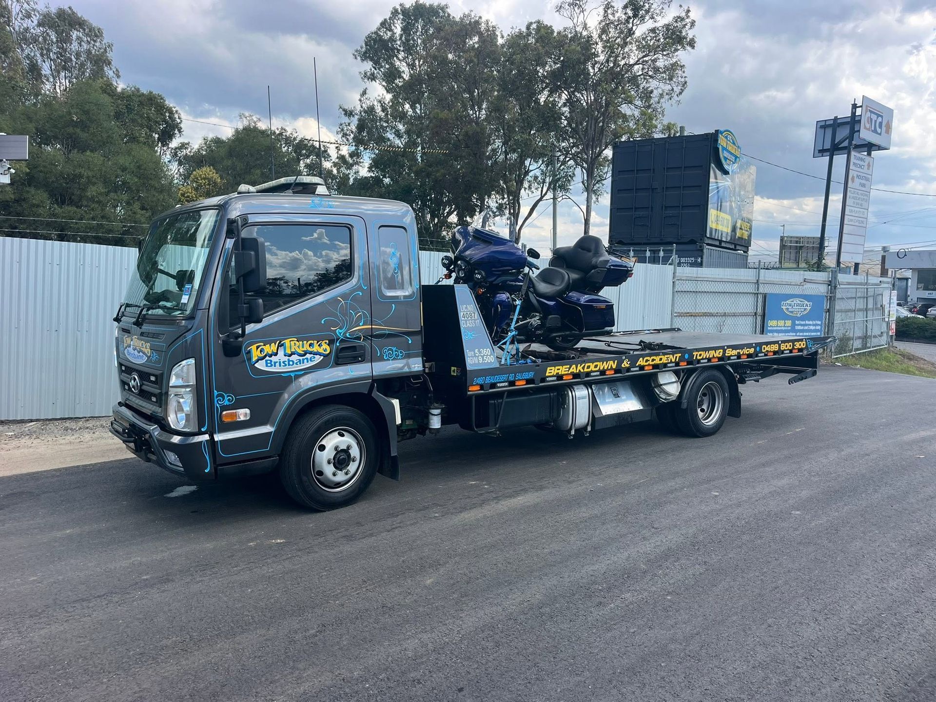 Blue Flatbed Tow Truck Carrying Equipment on a Roadside — A B & Forge Towing In Bribie Island, QLD