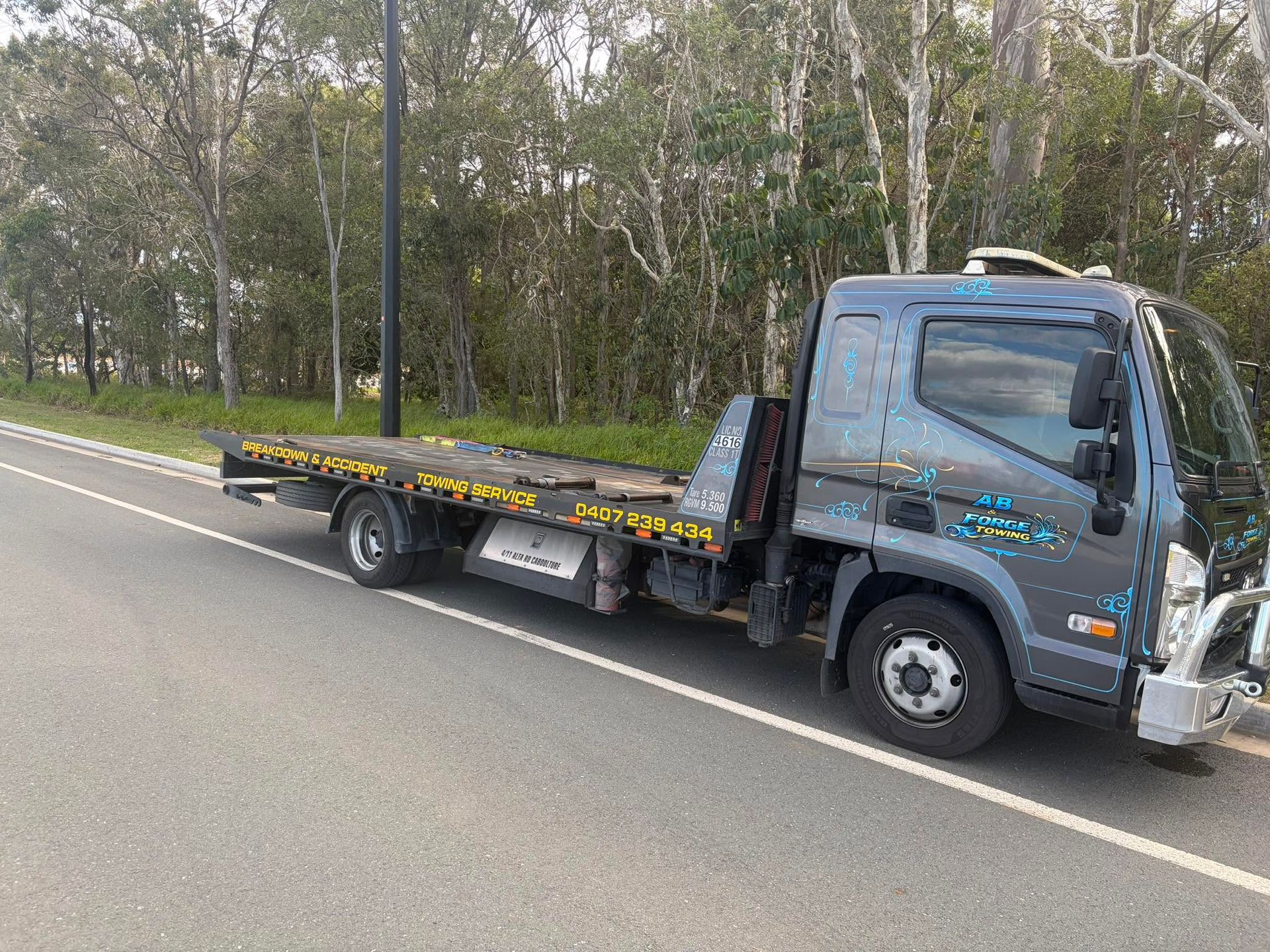Tow Truck Parked on a Roadside With Trees in the Background — A B & Forge Towing In North Lakes, QLD