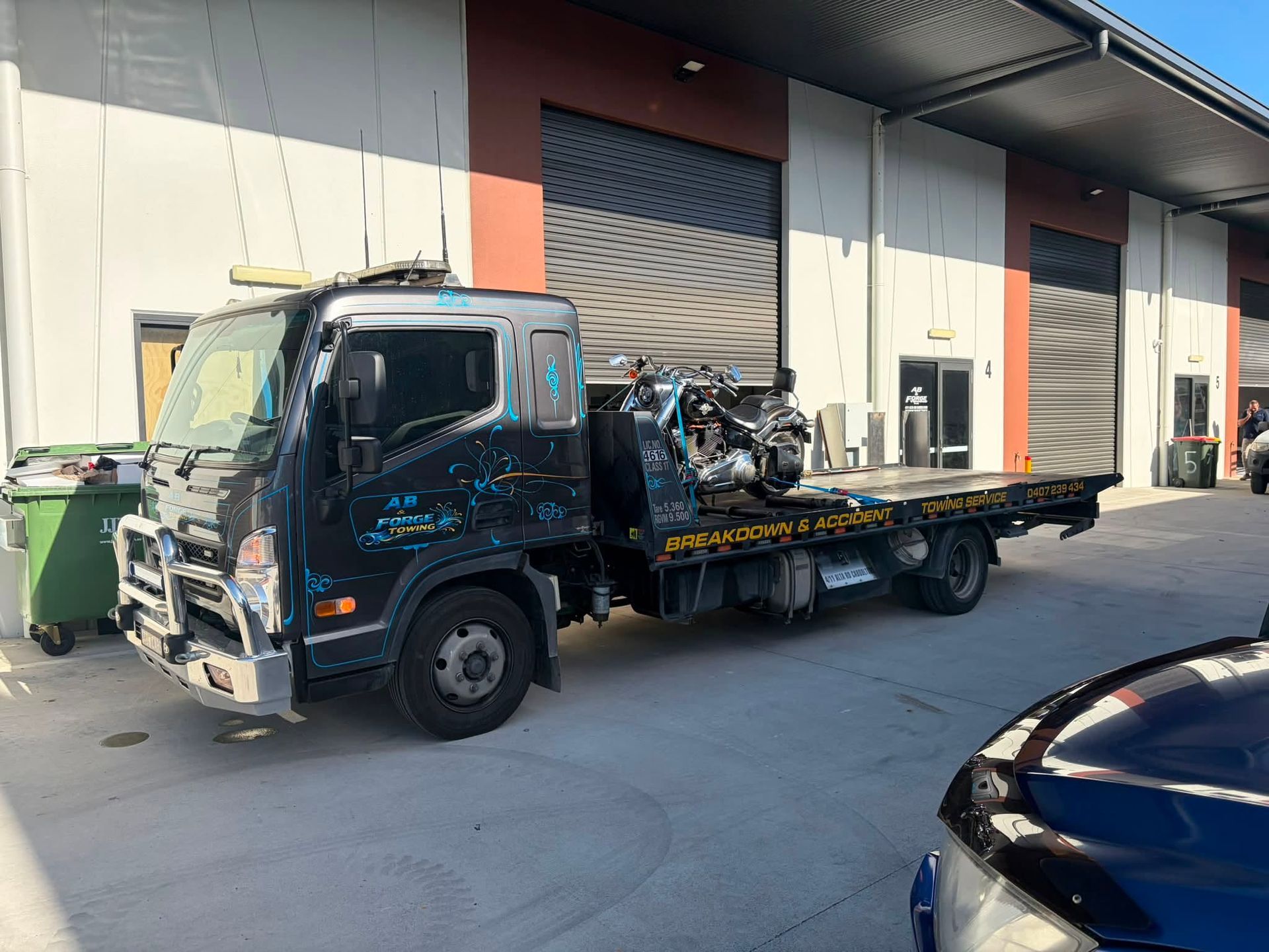 Tow Truck Parked Outside a Warehouse Loading Dock — A B & Forge Towing In North Lakes, QLD