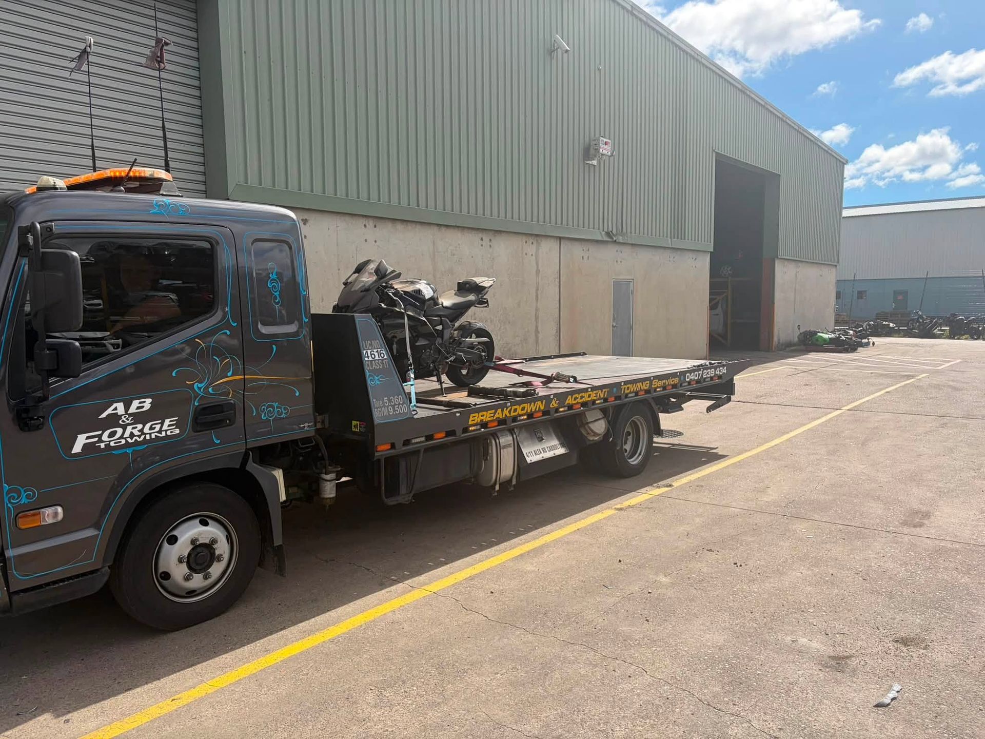 Tow Truck With Damaged Vehicle Parts Parked — A B & Forge Towing In Burpengary, QLD