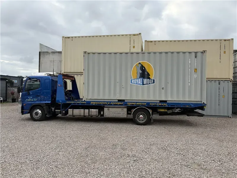 Blue cargo truck parked outside a warehouse loading dock — A B & Forge Towing In Caboolture, QLD