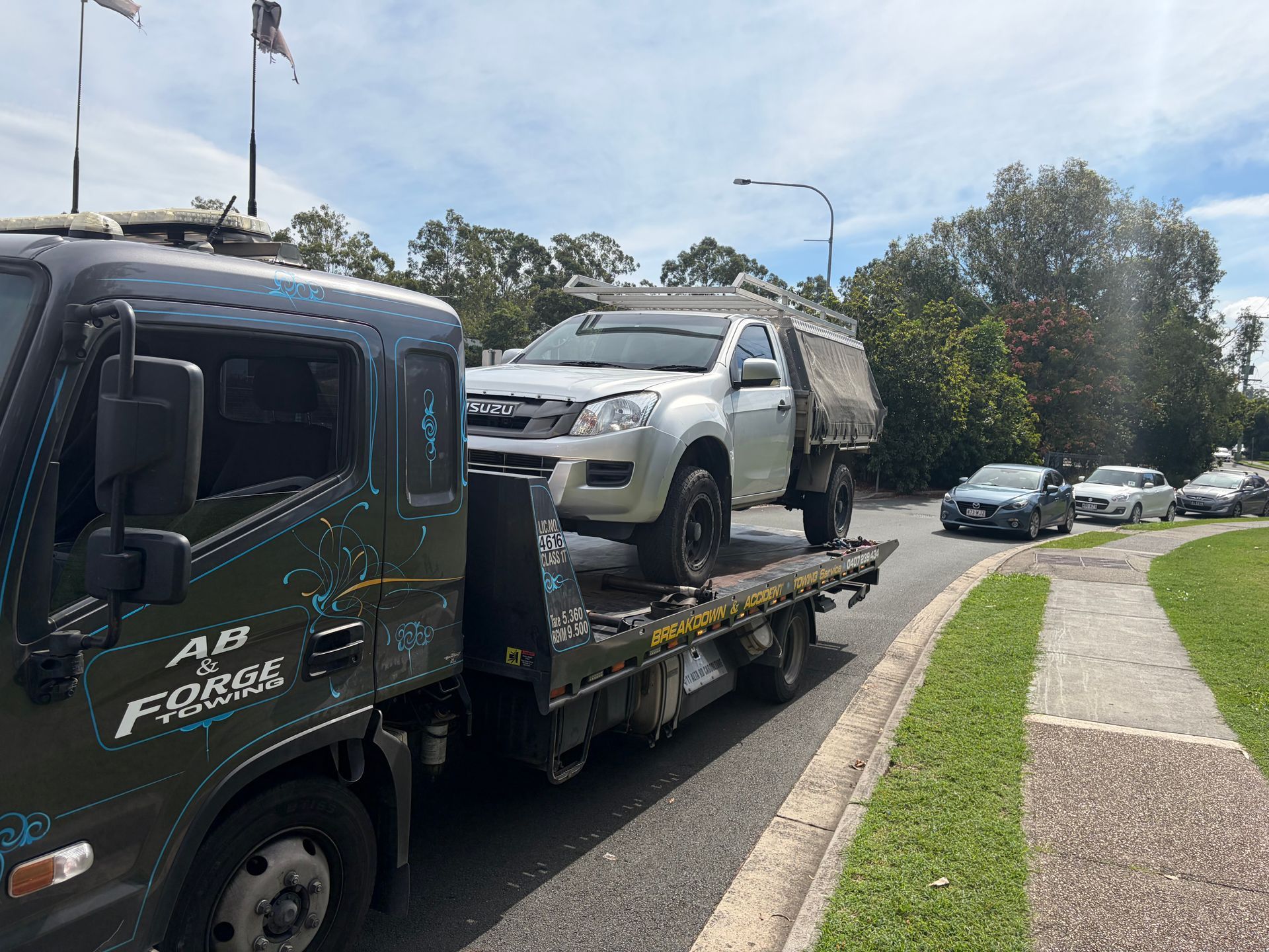 Tow Truck Carrying a Silver Pickup on a Flatbed — A B & Forge Towing In Bribie Island, QLD