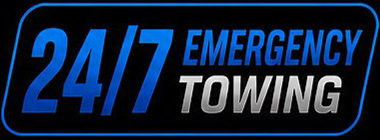 Blue and white 24/7 Emergency Towing sign on a black background