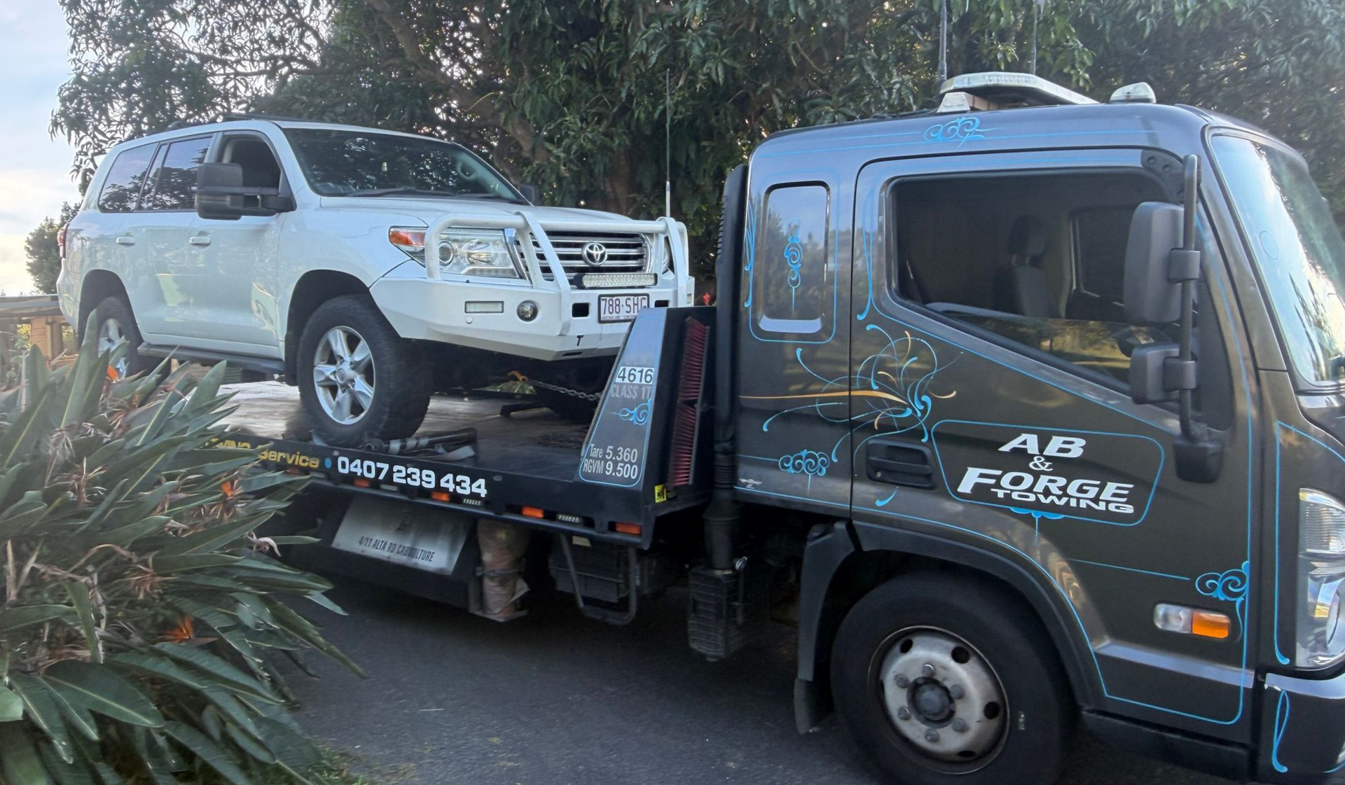 White SUV on a Flatbed Tow Truck — A B & Forge Towing In Caboolture, QLD