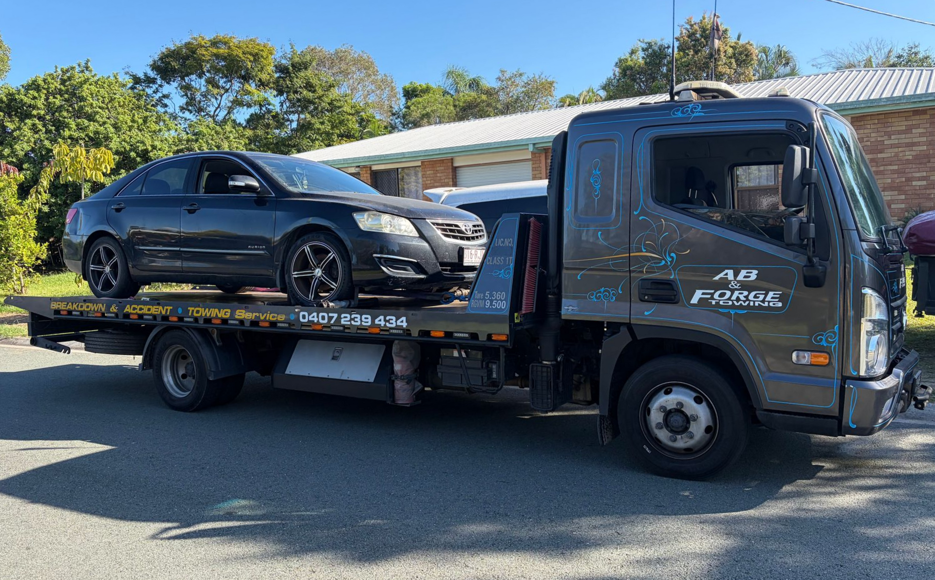 Tow Truck Carrying a Black SUV on a Flatbed — A B & Forge Towing In Caboolture, QLD