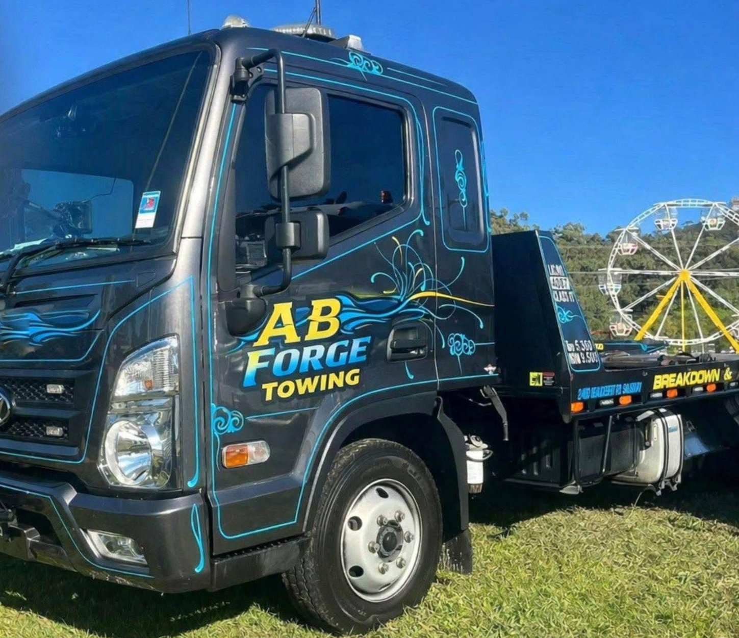 Tow Truck Carrying a Silver Sedan on a Flatbed Trailer Outdoors — A B & Forge Towing In Caboolture, QLD