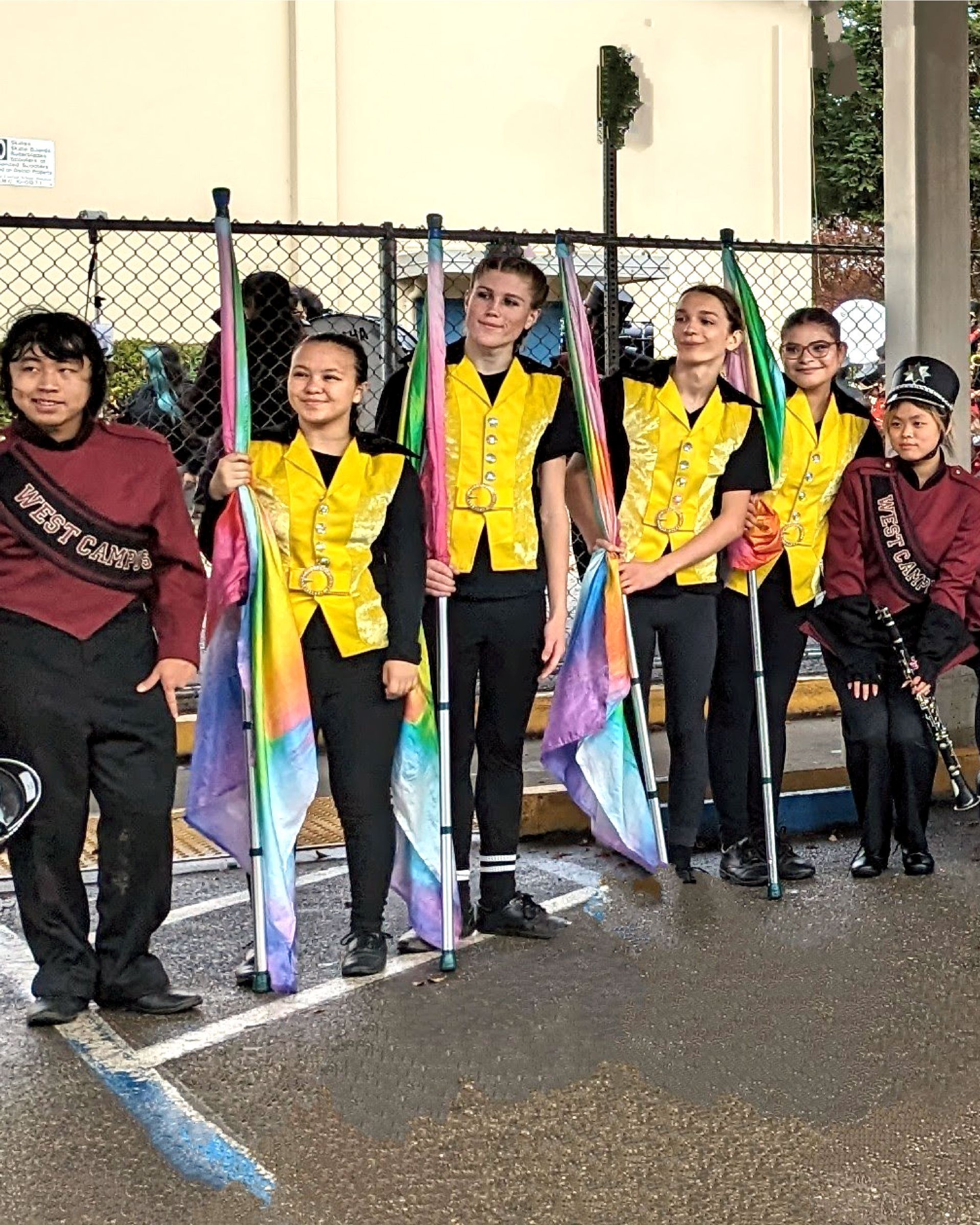 A group of people standing next to each other holding flags in a parking lot.