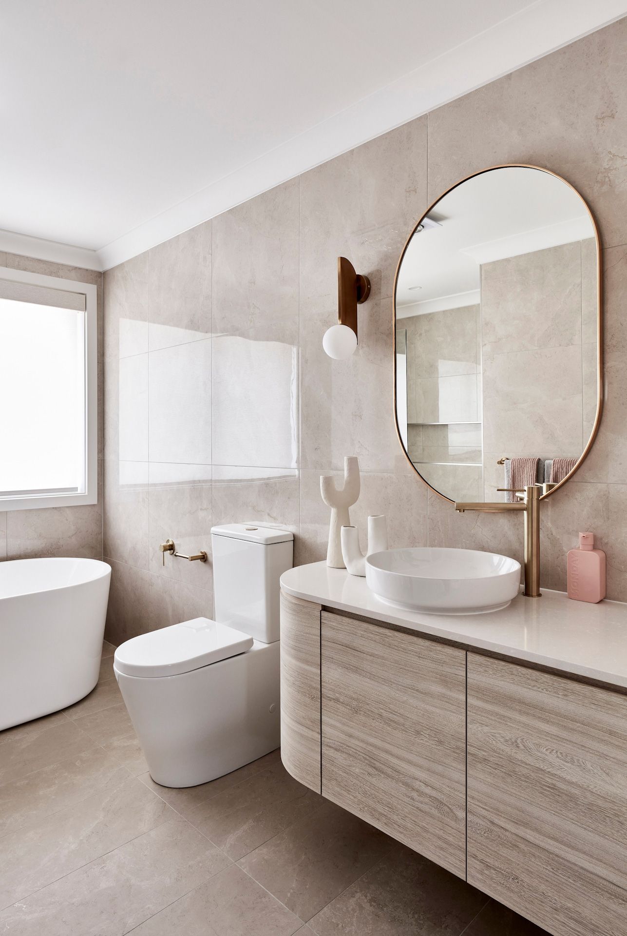 A bathroom with a toilet, sink, bathtub and mirror.