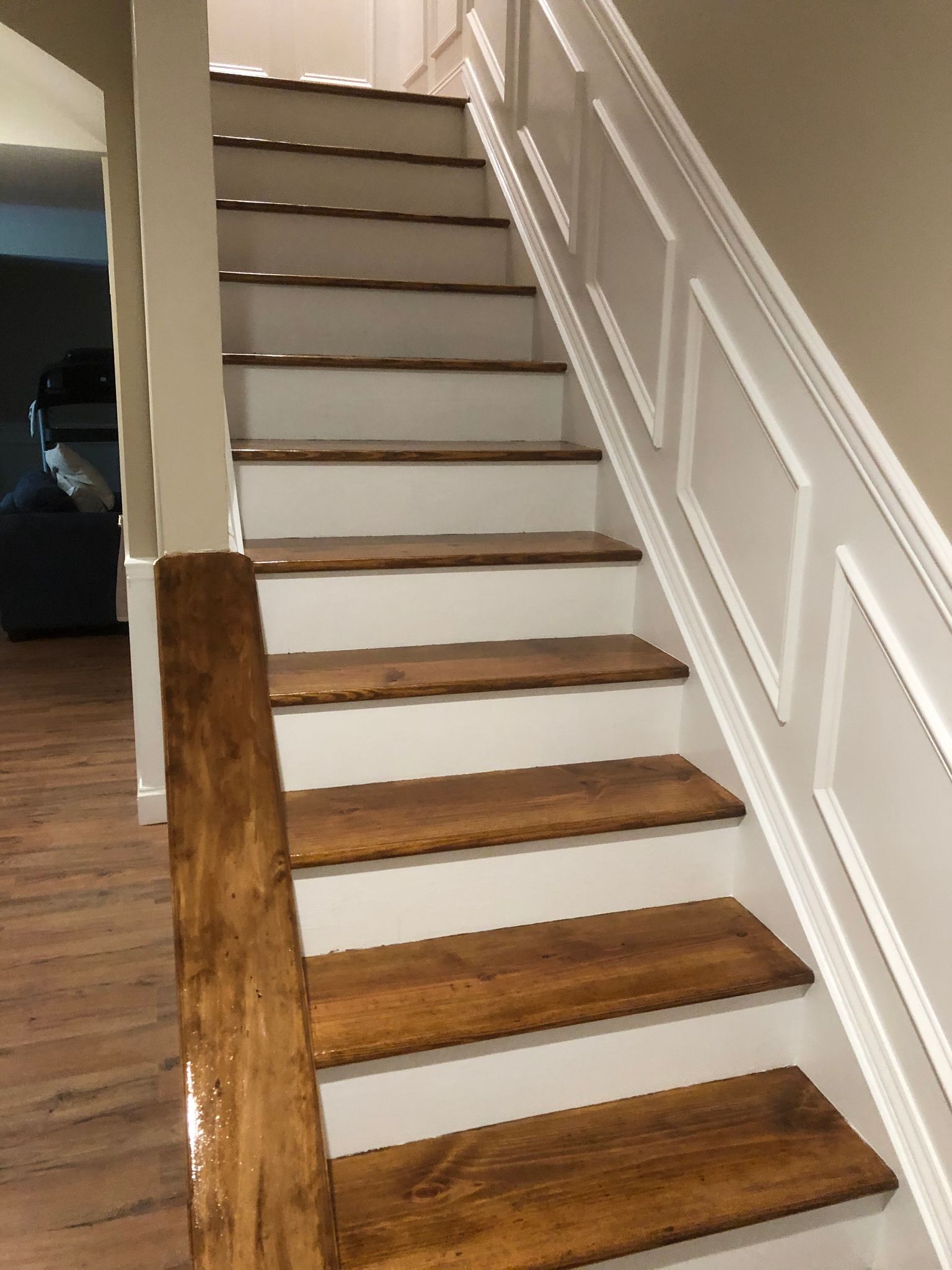 A staircase with wooden steps and a white railing in a house.